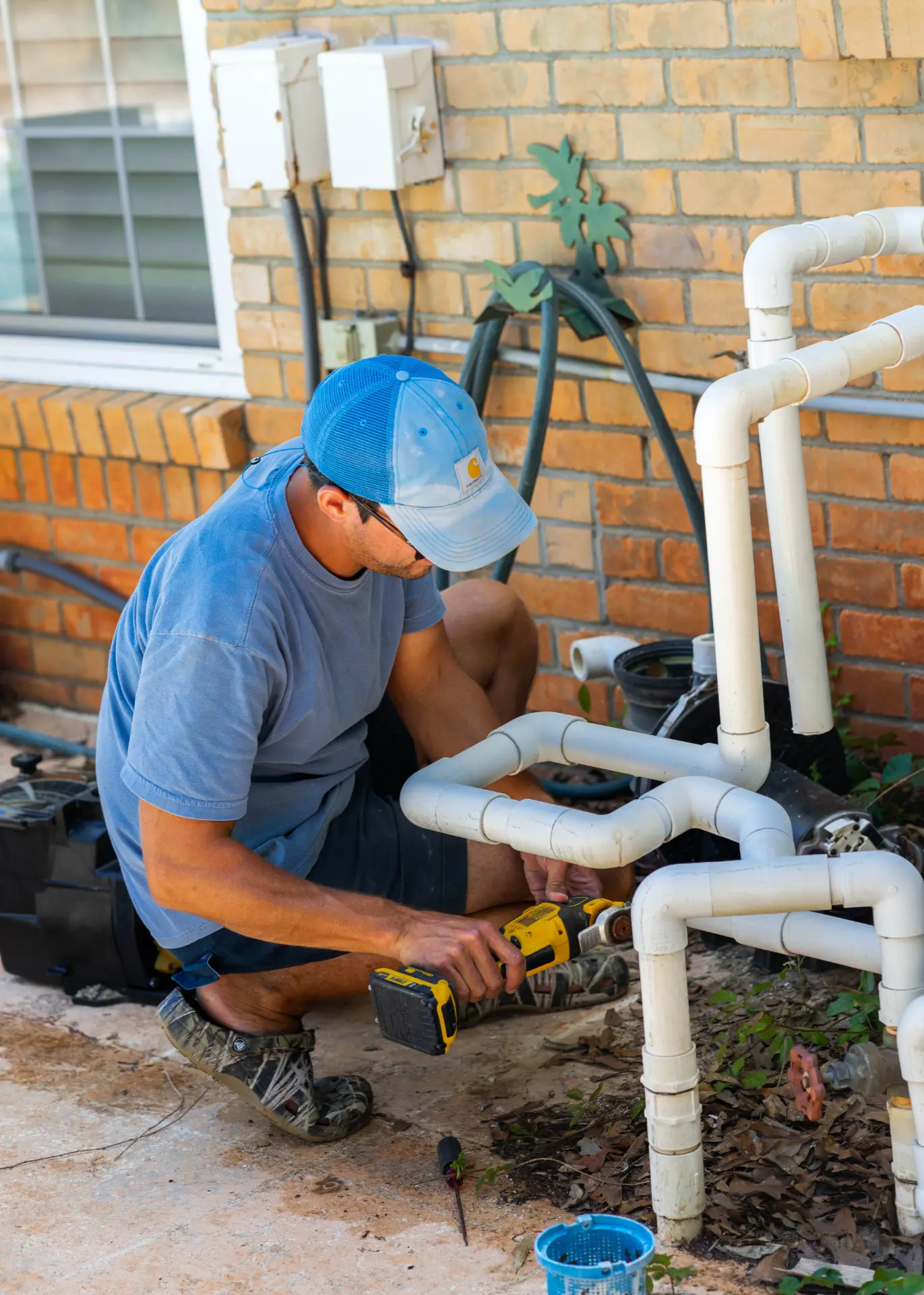 Technician repairing pool equipment plumbing