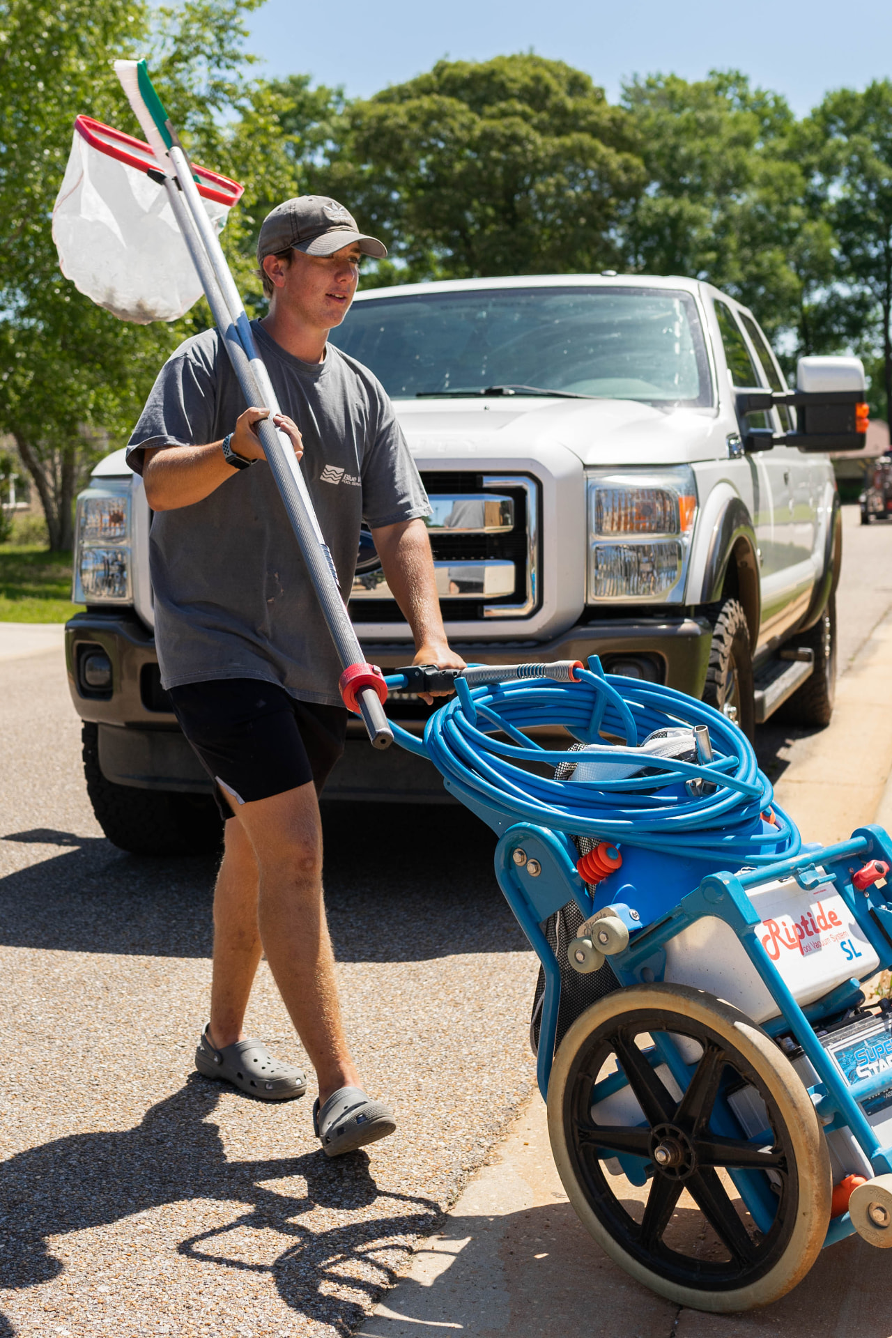 Technician unloading equipment from a service truck